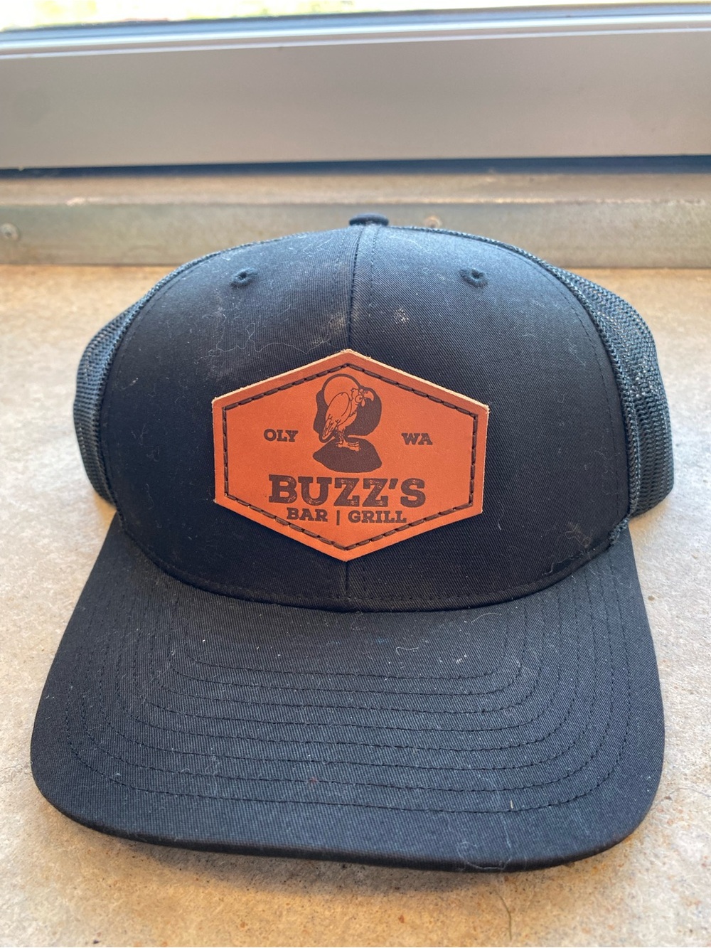 Buzz's Bar & Grill Black Patch Trucker Hat
